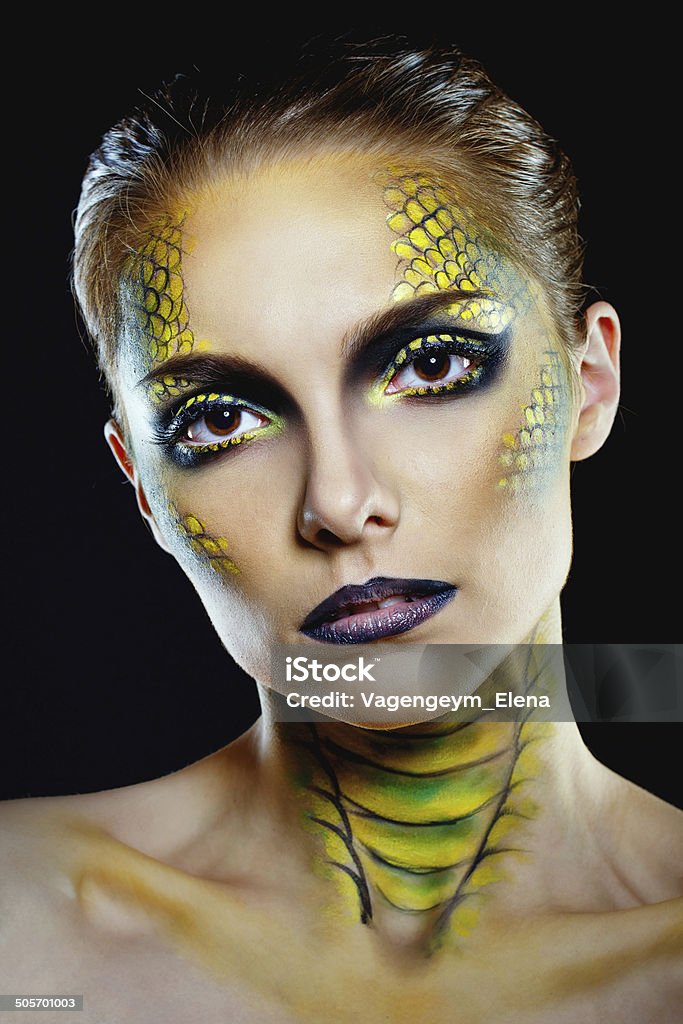 Snake girl Attractive young woman in makeup snake shot in the studio Adult Stock Photo