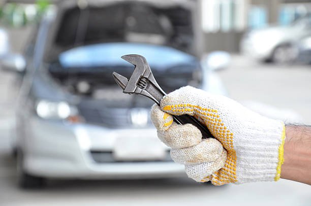 istock Hand holding wrench - car checking & repairing concept 505701123