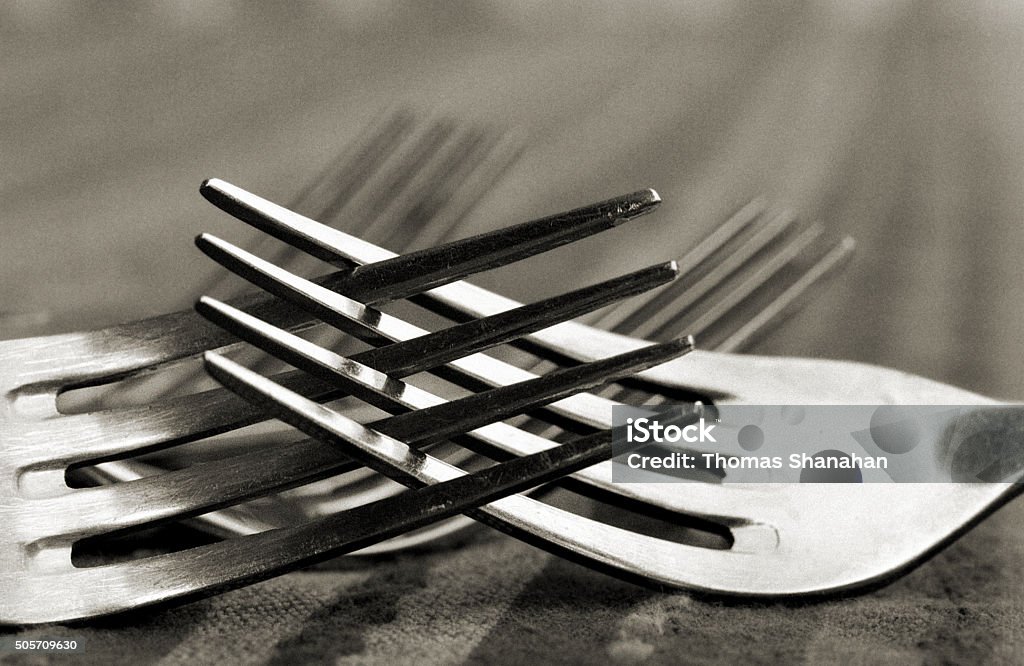 Romantic or Possibly Angry Forks Two entangled forks Abstract Stock Photo