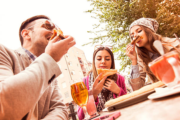 istock Young group of laughing people eating pizza and having fun 505709742