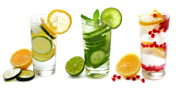 Three types of detox water with fruit in glasses isolated on a white background
