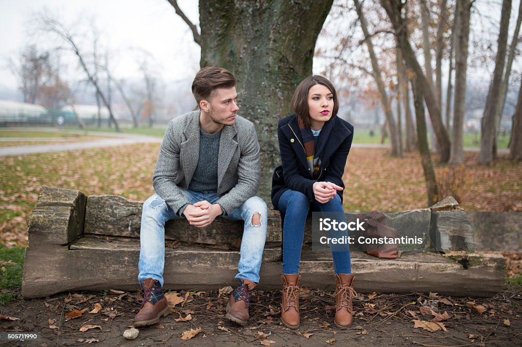 Relationship difficulties Young couple sitting on the bench in the park, having relationship difficulties. Couple - Relationship Stock Photo