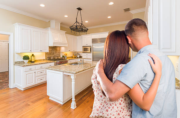 istock Young Hopeful Military Couple Looking At Custom Kitchen 505712122