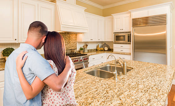 istock Young Hopeful Military Couple Looking At Custom Kitchen 505712134