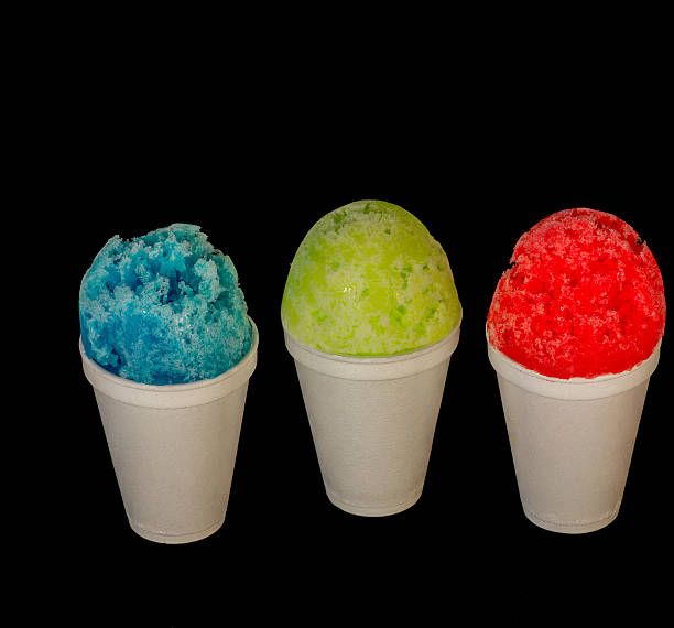 istock Red,green,blue shaved ice servings against a black background. 505712632