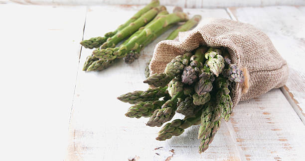 istock Bunches of asparagus lying on a wooden table 505713970