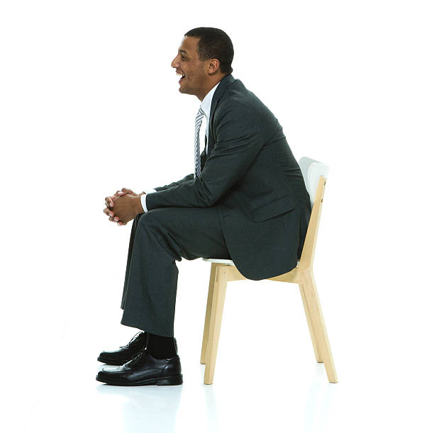 istock Smiling businessman sitting on chair 505714040