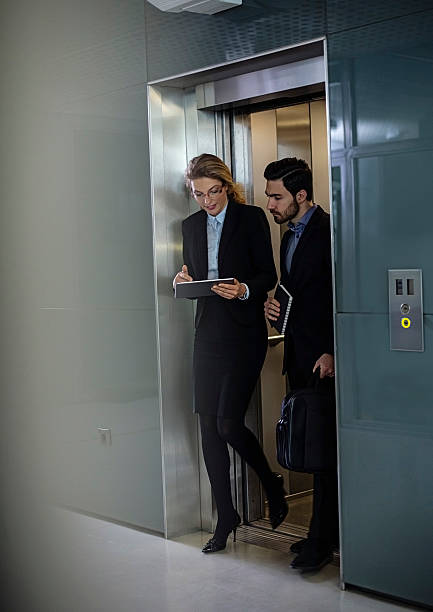 istock Business coworkers  walking out of elevator 505714174