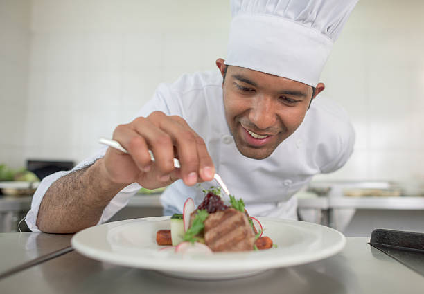 istock Chef decorating a plate of food 505715048