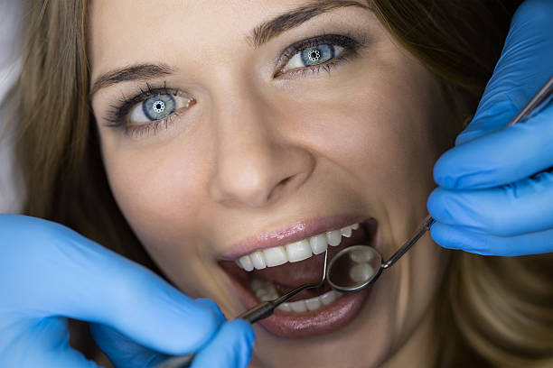 istock Dentist examining a patient's teeth in the dentist 505715914
