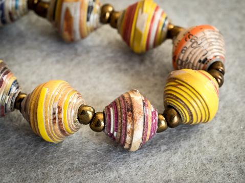 paper strips, rolled and formed into beads for jewelry