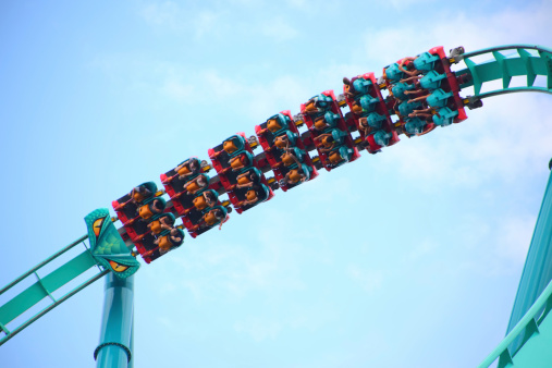 An image of people riding the Leviathan rollercoaster upside down at Canada's Wonderland amusement park in Vaughan, Ontario, Canada. The fastest and tallest rollercoasetr in Canada. People in an amusement park. Enjoying the rollercoaster, Thrill, fun and excitement of riding a rollercoaster. See more in my portfolio