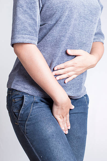 istock Woman with Hands Holding her Crotch 505721412