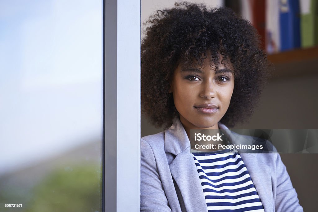 Setting out to achieve in business Portrait of a young businesswoman leaning agains a screen door 20-29 Years Stock Photo