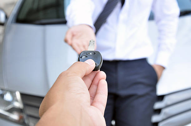 istock Hand giving a car key to another man 505722127