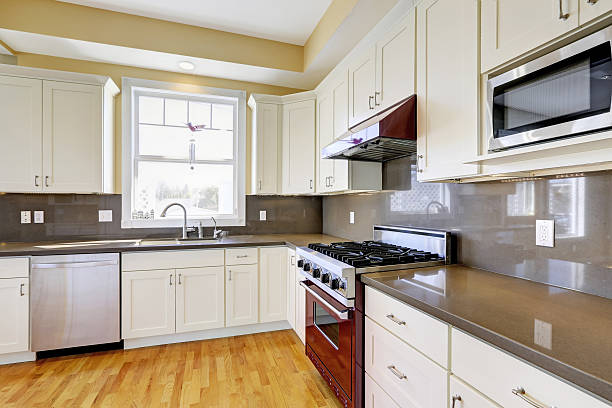 istock White kitchen with burgundy stove and grey counter tops 505722437
