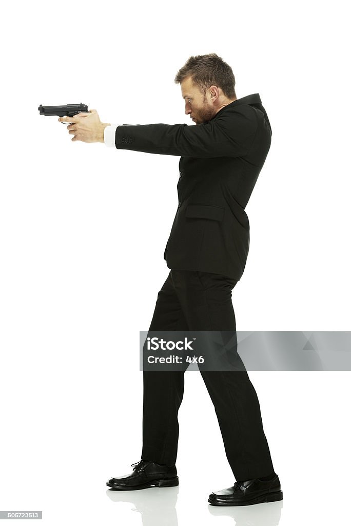 Geschäftsmann mit einer Waffe in Aktion - Lizenzfrei Anzug Stock-Foto