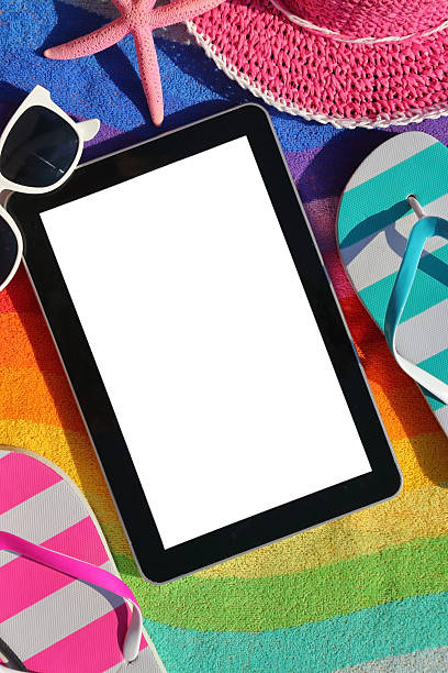 istock Tablet with blank screen on beach towel with accessories 505723687