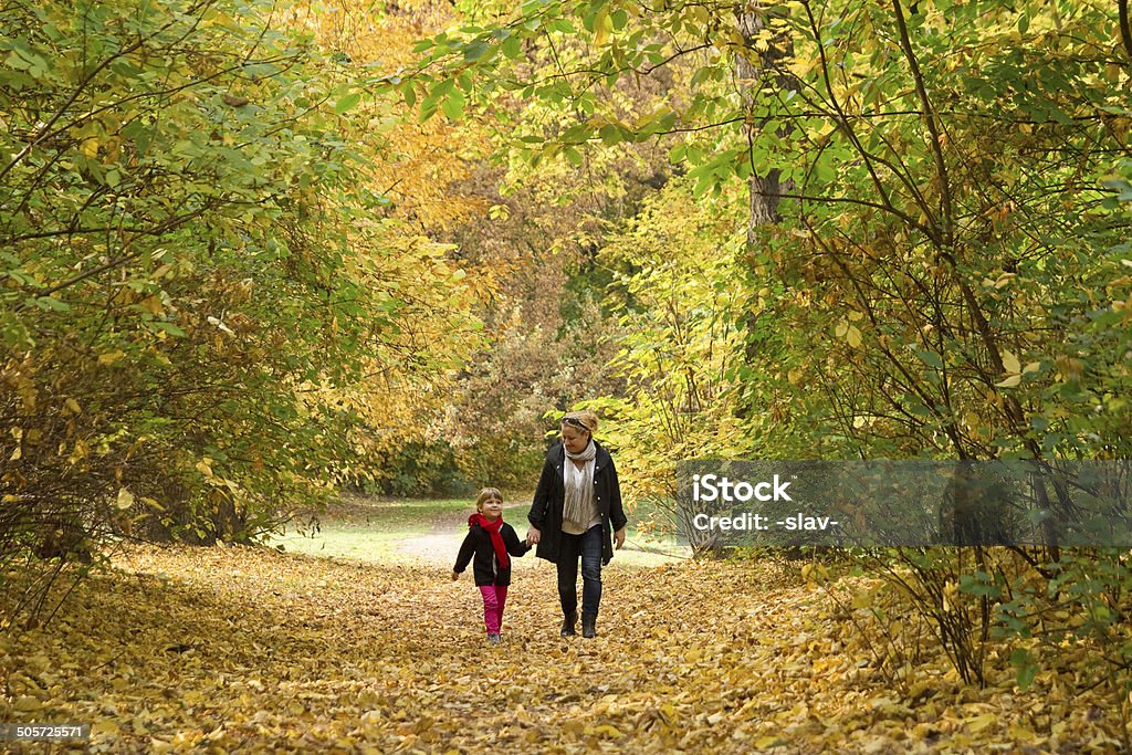 autumn walk mother walking with daughter in autumn park Alley Stock Photo
