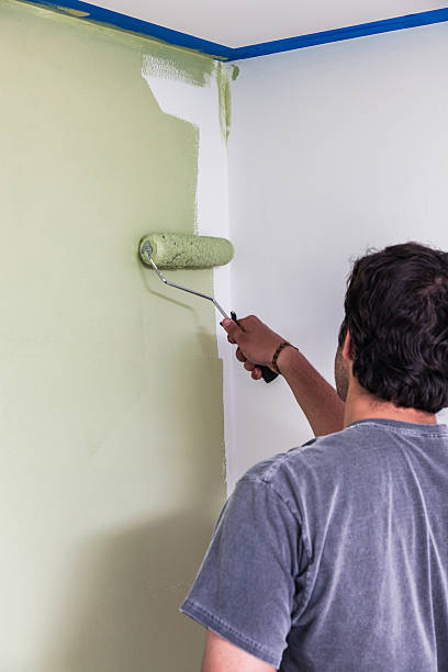 istock Young Man Painting Bedroom Wall 505726309