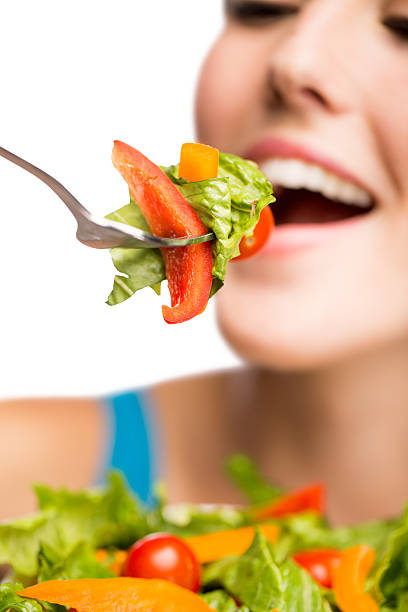 istock Young hispanic woman eating salad 505726563