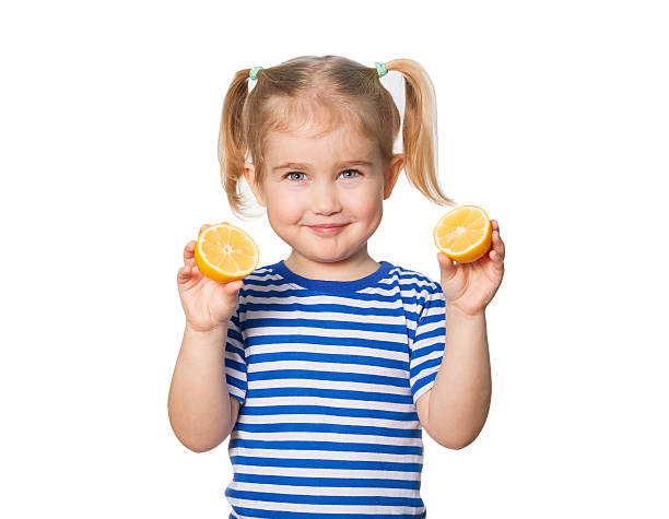 istock Little Funny girl keeps lemons 505744508