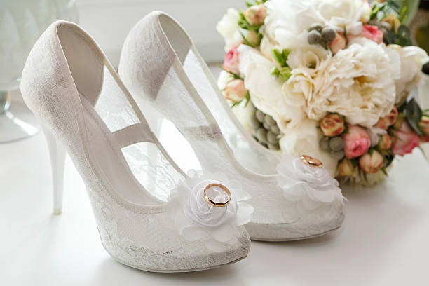 istock wedding ring on the bride's shoes. 505745162