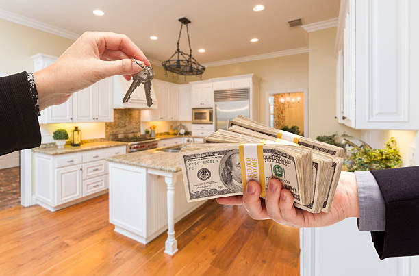 istock Handing Over Cash for Keys Inside Beautiful Kitchen 505746086
