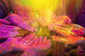 Hands and colorful powders of the holi festival