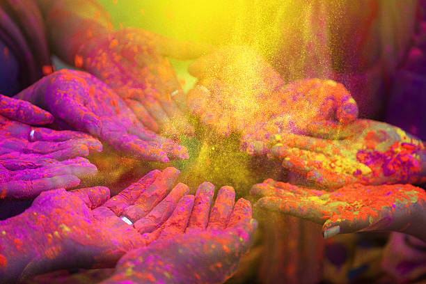 hands and colorful powders of the holi festival - 爽身粉 圖片 個照片及圖片檔