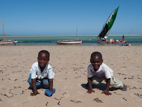 Vilanculos, Mozambique - December 23, 2009: Local kids playing with the sand by the beach in Vilanculos, Mozambique