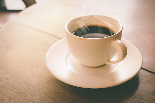 istock Cup of coffee on wooden table 505750276