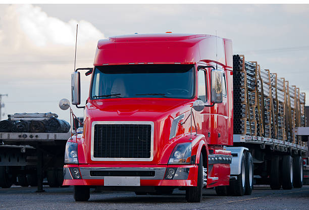 istock Modern semi truck flat bed trailer with cargo on parking 505750856
