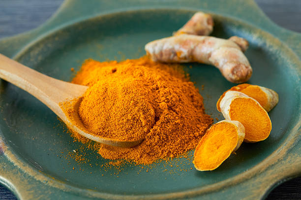 Turmeric Turmeric root and turmeric powder , close up turmeric stock pictures, royalty-free photos & images