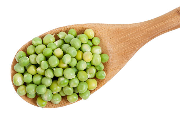 istock Green peas in wooden spoon 505752058