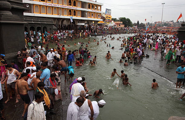 Maha kumbha mela Nashik,India-September 14, 2015: Unidentified devotees takes bath in the river Godavari during the event Maha Kumbh Mela in Nashik, India. god is love stock pictures, royalty-free photos & images