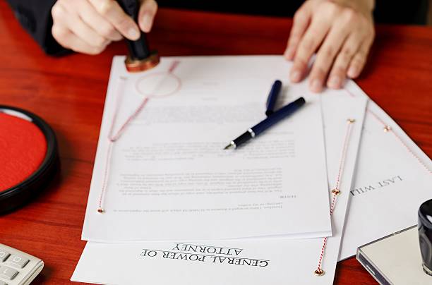 istock Notary's public hands stamping power of attorney. 505753908
