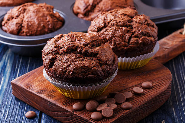 istock Chocolate muffins with chocolate drops on dark background. 505754310