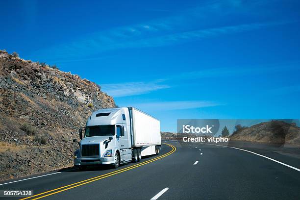 Modern Semi Truck And Trailer On Turning Rocky Windy Road Stock Photo - Download Image Now