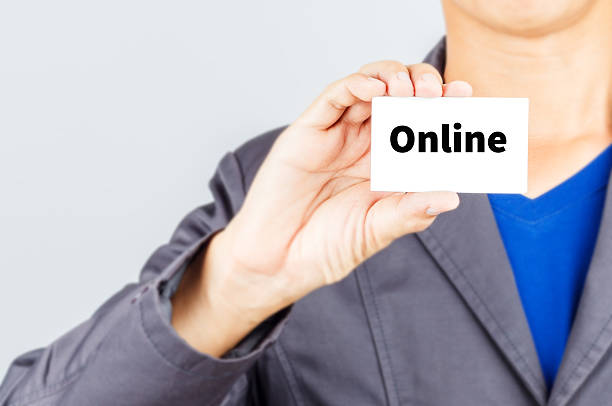istock ONLINE, message on the card held by a man hand 505755228