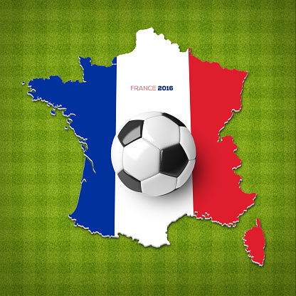 A soccer ball on a France map with a France flag on a top view of green stripped soccer field.