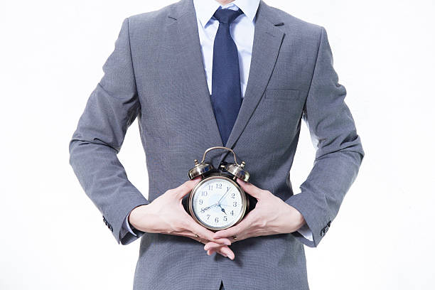 istock Man in Business Suit holding a clock 505756166
