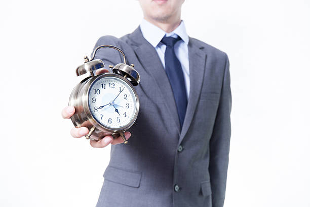 istock Man in Business Suit holding a clock 505756964