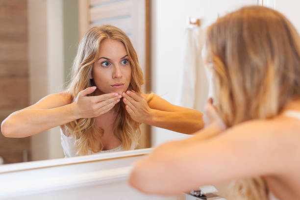 istock Woman removing pimple from her face 505767075