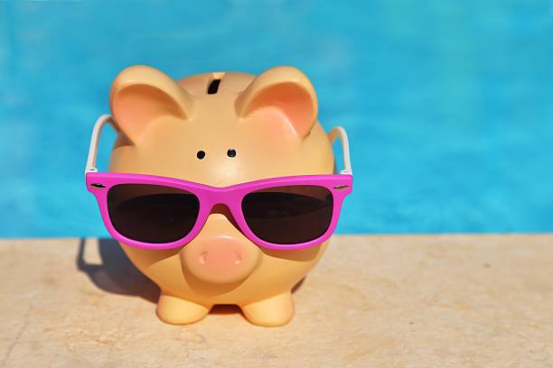 istock Summer piggy bank with sunglasses 505768077