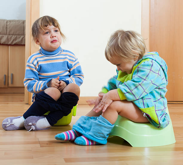 istock children sitting on bedpans 505769397