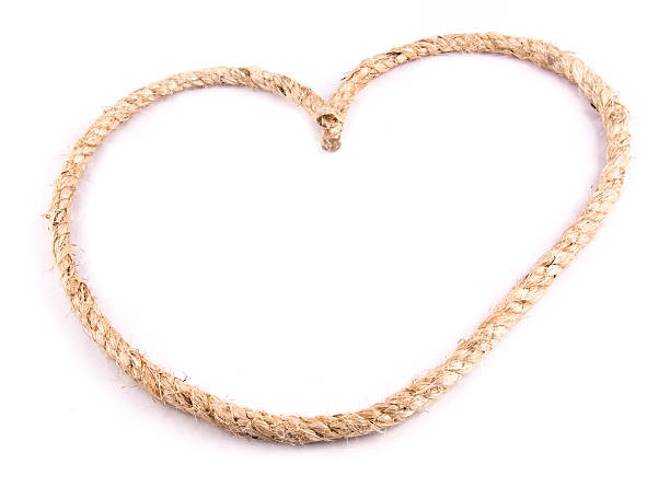 istock Heart Shaped Knot on a Jute rope on white background 505769897