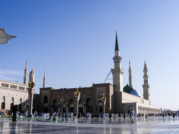 istock Pilgrims walk outside Al Nabawi mosque after morning prayer 505771081