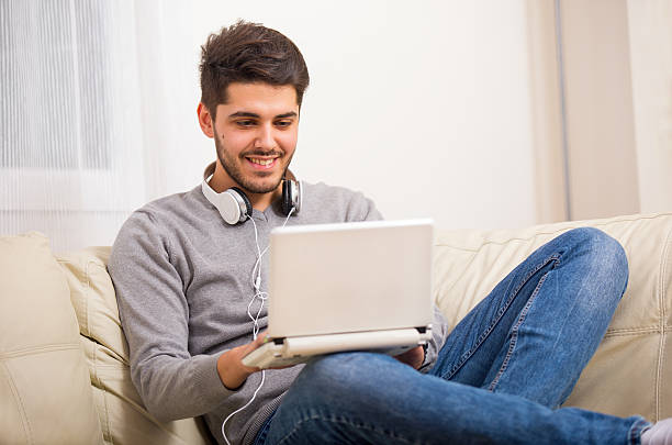 istock Young man at laptop 505771142