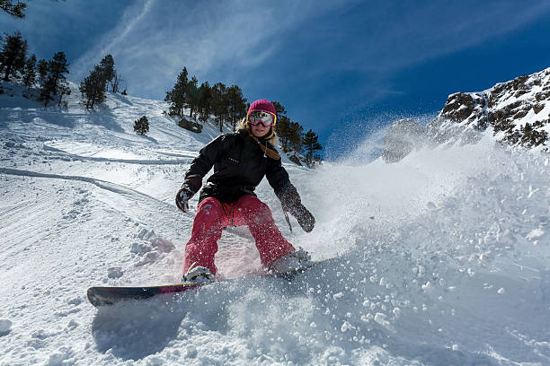 istock Woman snowboarder in motion in mountains 505772032